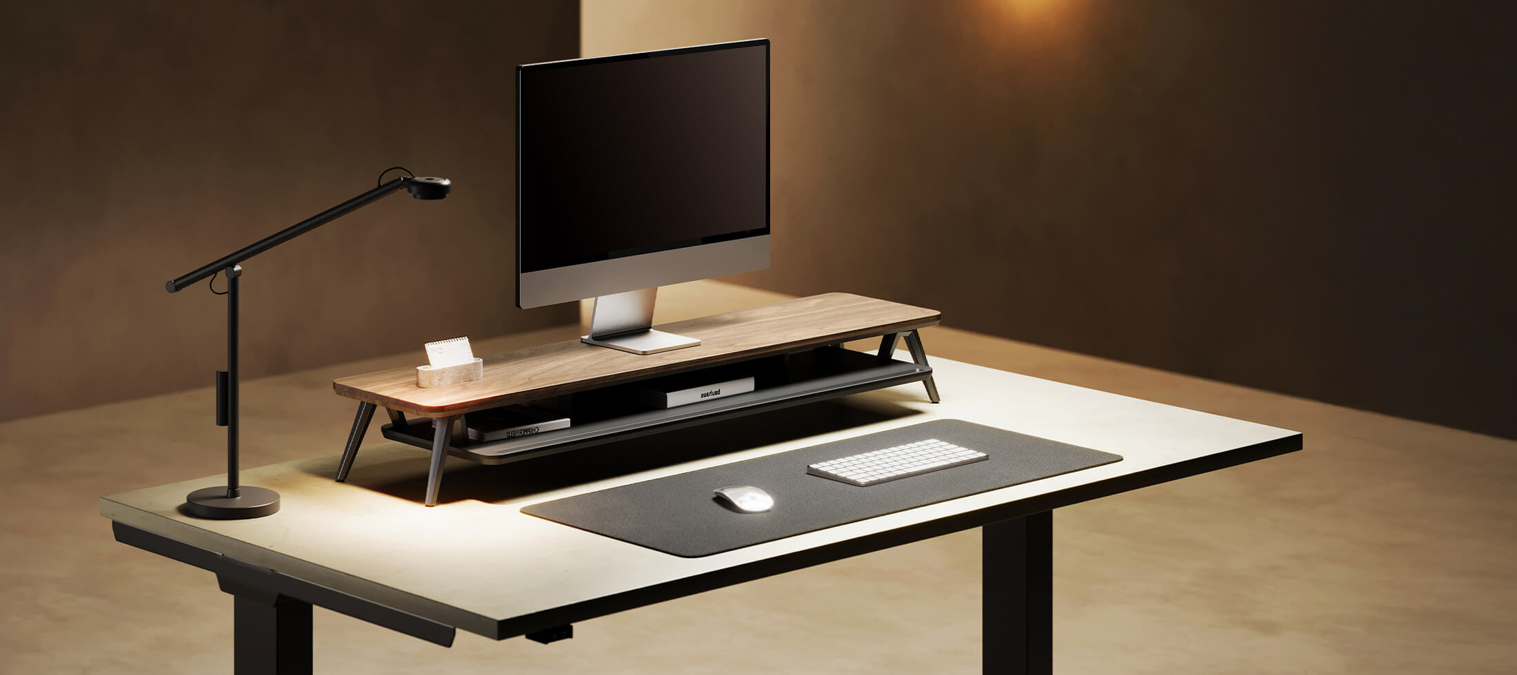 Modern office desk setup with computer monitor, keyboard, mouse, and microphone on a neutral background