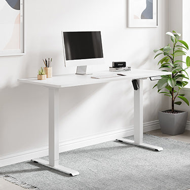 White standing desk on home office with plant