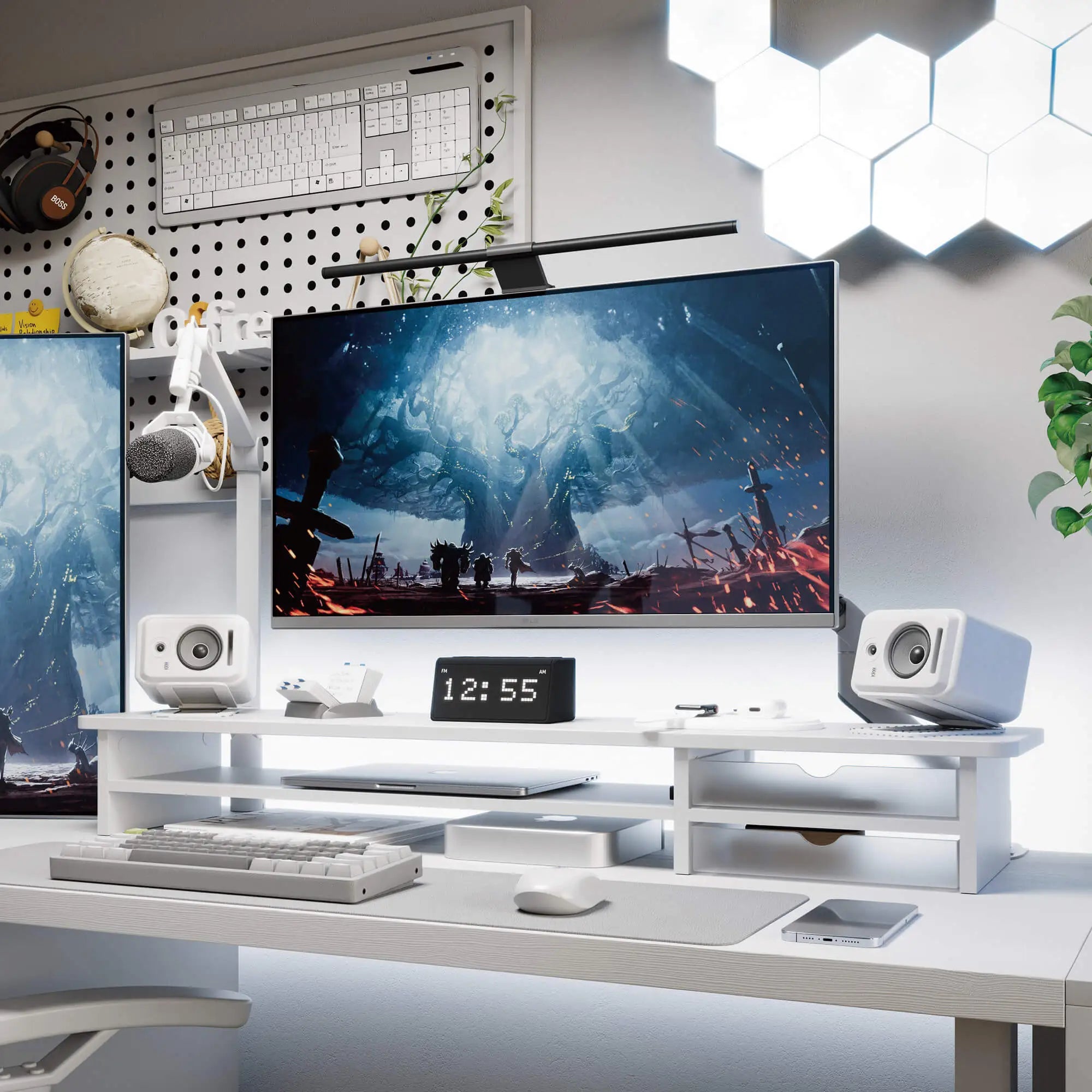 Modern office desk setup with computer monitor, speakers, and decor.