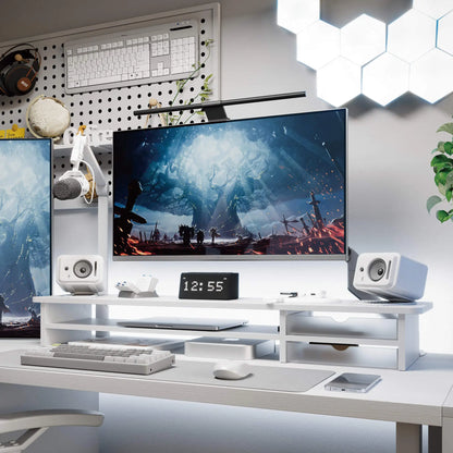 Modern office desk setup with computer monitor, speakers, and decor.