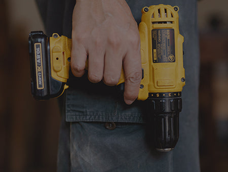 A man's hand holds the installation tool
